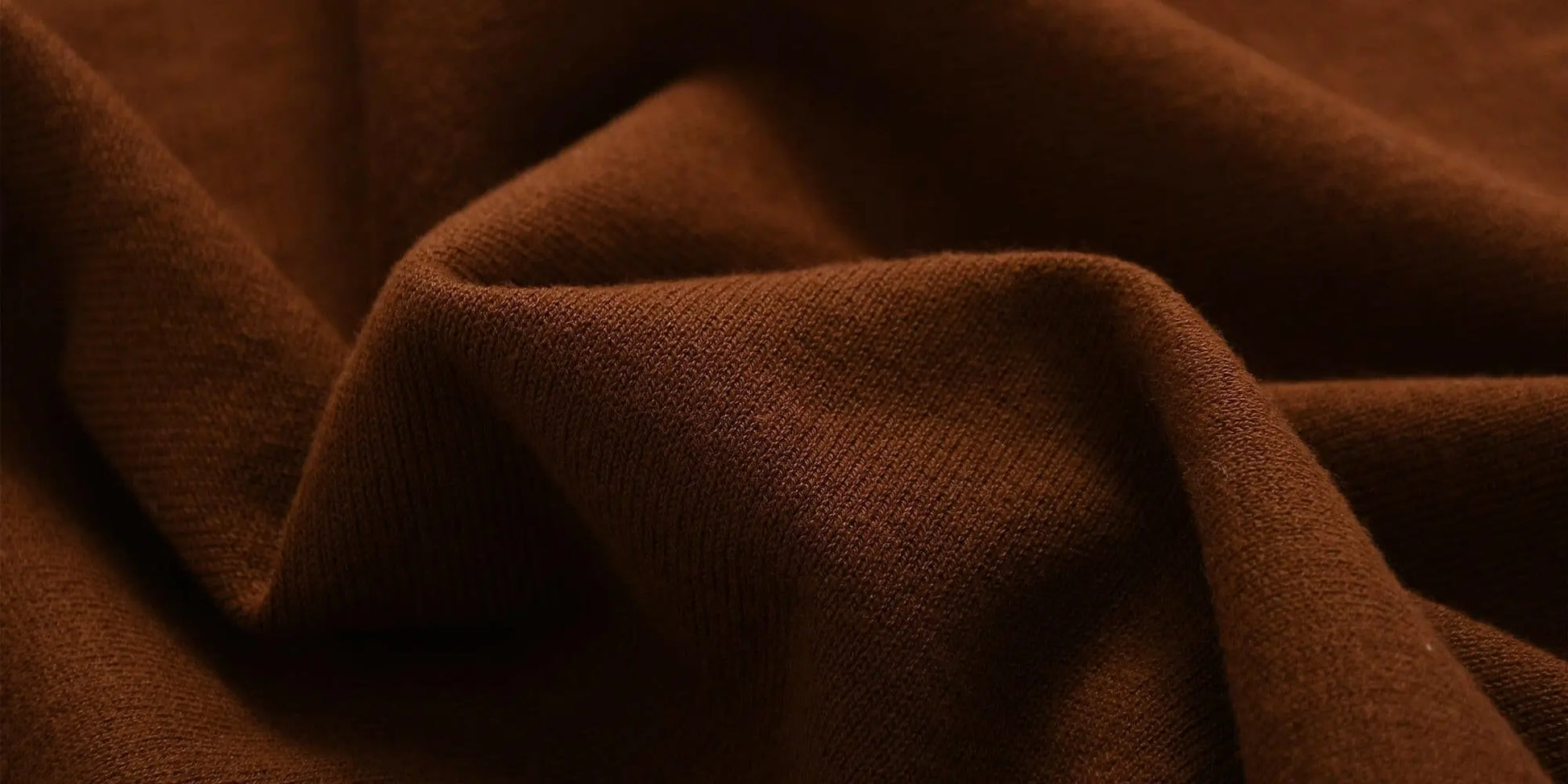a close up of a blanket on a bed 